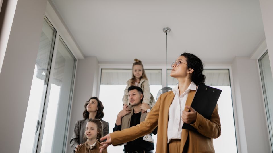 property manager showing a family of four around a house